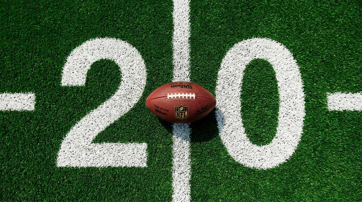 NFL football resting on yard-line markings of a professional gridiron pitch
